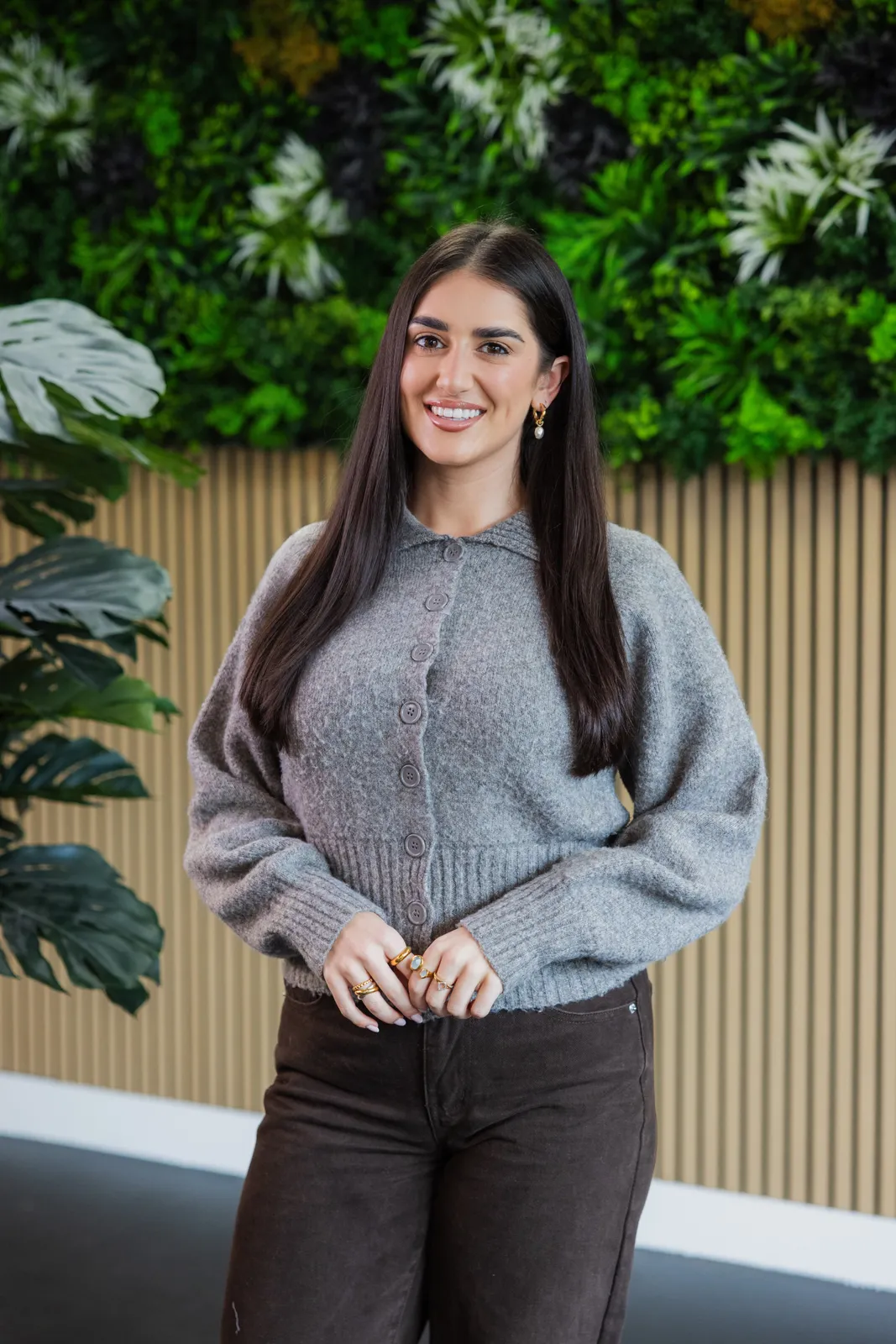 Portrait of a member of the club team in front of a green wall