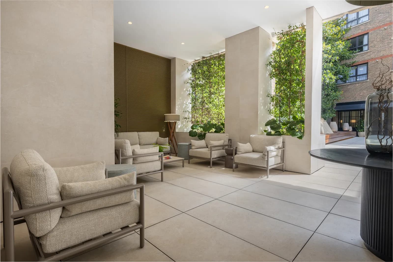 A bright entrance lounge with armchairs and a green wall