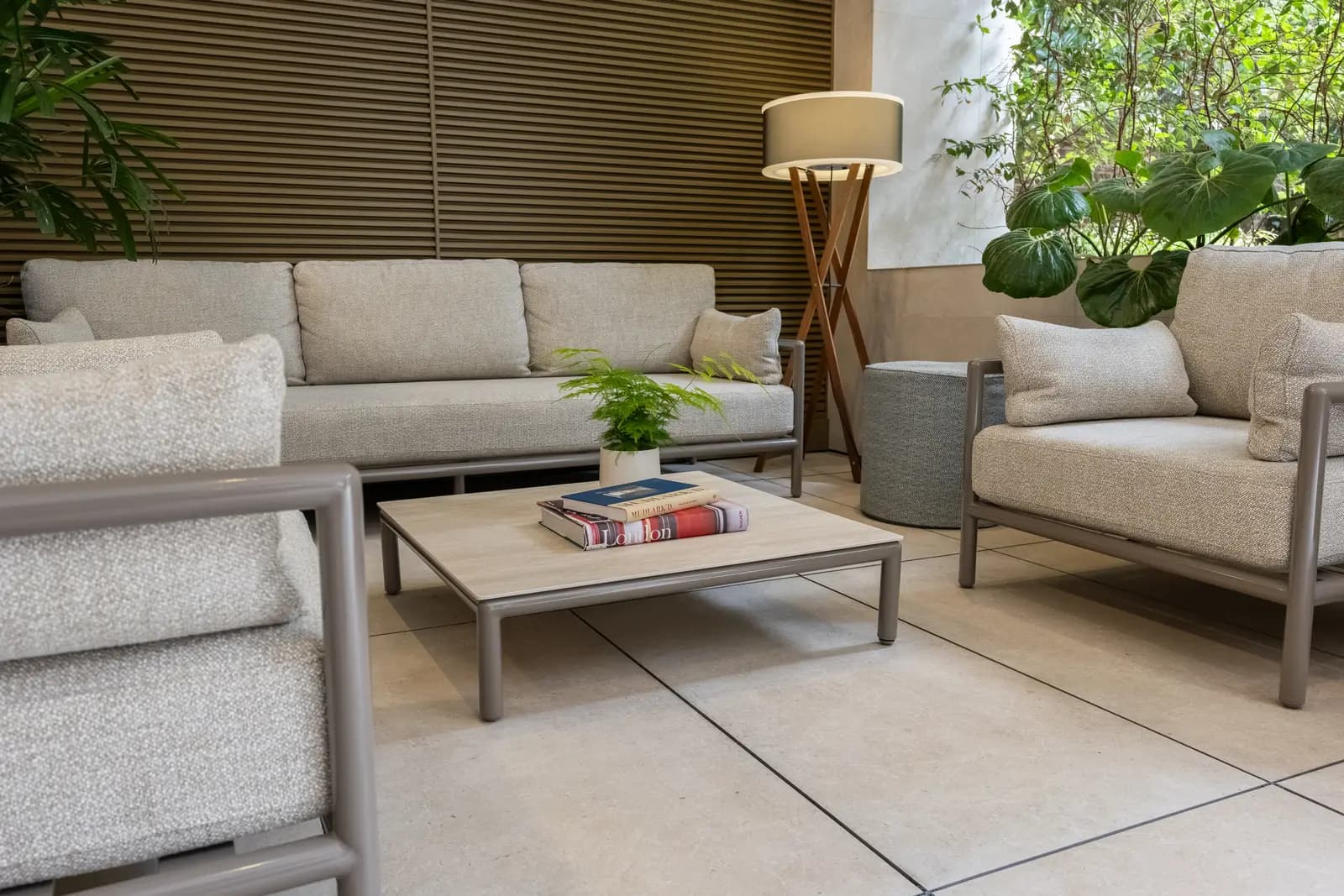 Sofas and a coffee table in a lounge with a living green wall
